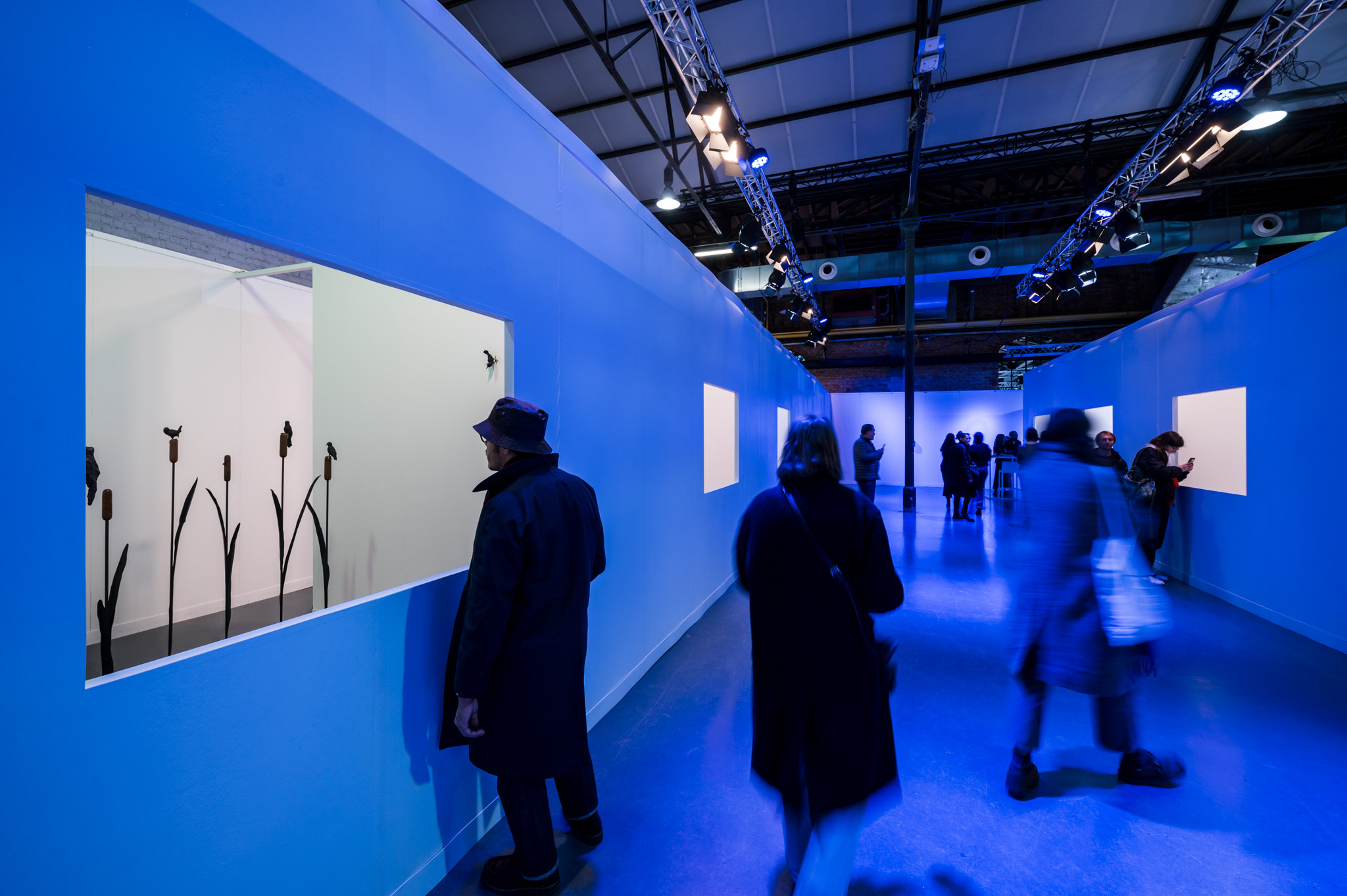 Blue-lit gallery corridor at Ceramic Brussels