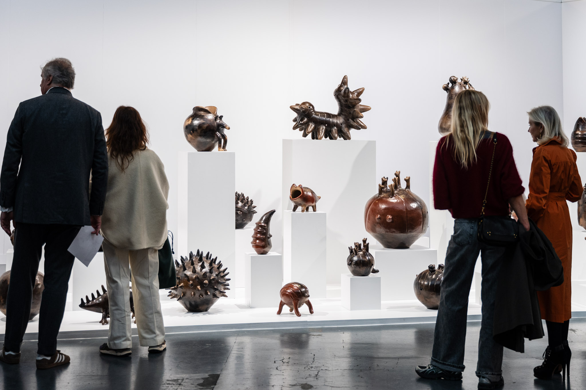 Visitors viewing ceramic sculptures